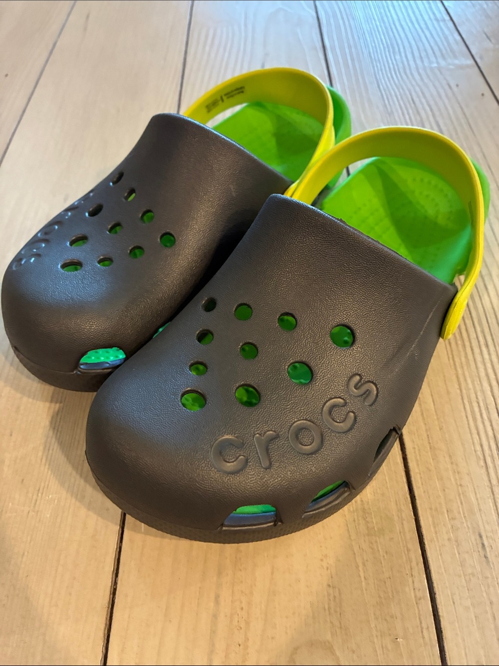 Green, gray and yellow crocs
